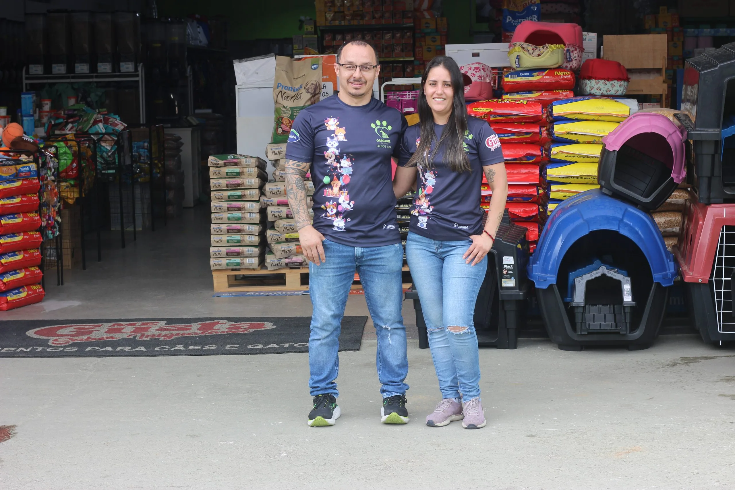 Gargamel com sua namorada Juliana em frente a loja