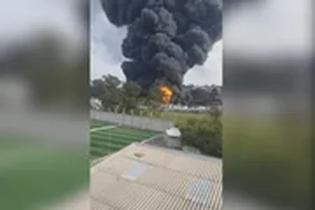 Fábrica foi evacuada preventivamente após incêndio atingir tanques de solventes. Imagens mostram chamas intensas e muita fumaça preta